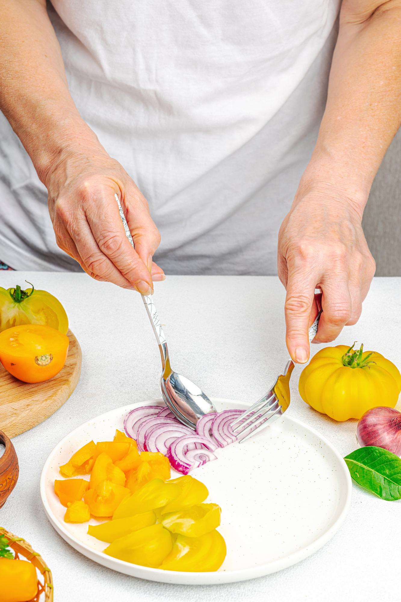 Chef preparing a colorful dish on a wooden table